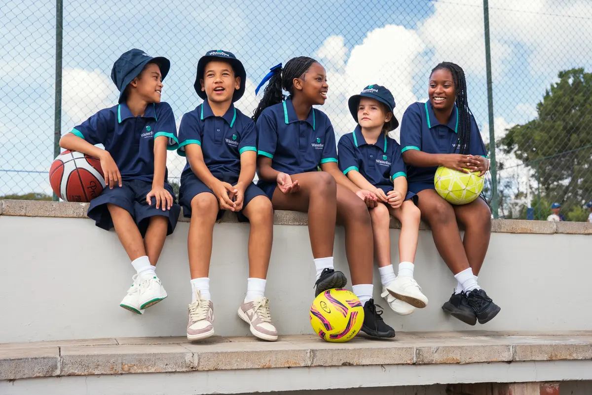 A group of Waterford College students sitting together with sports balls
