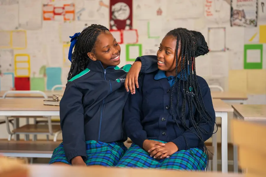Two students sitting and laughing together