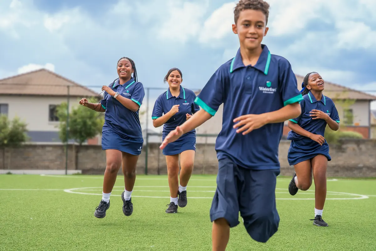 Waterford College students running together on the field