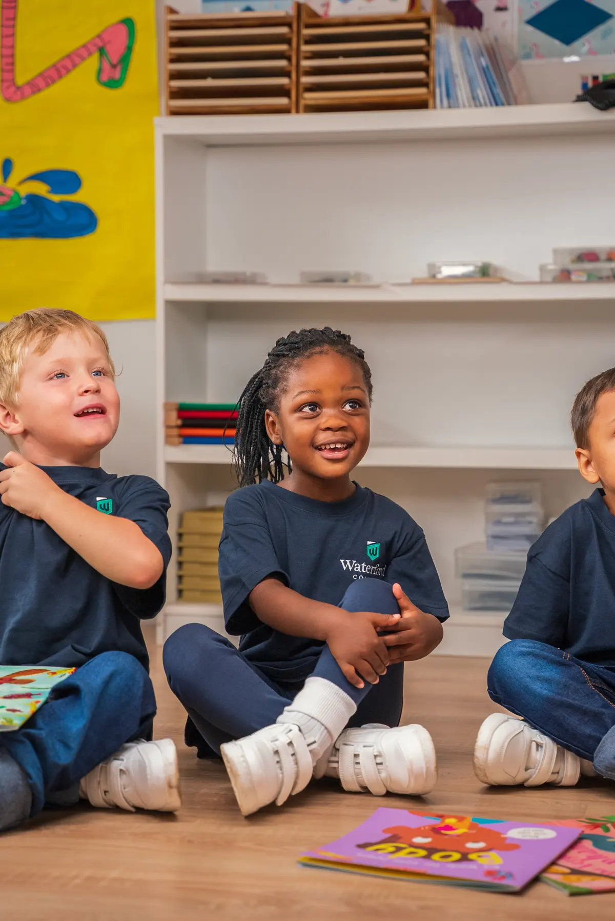 Young children sitting together on the classroom floor