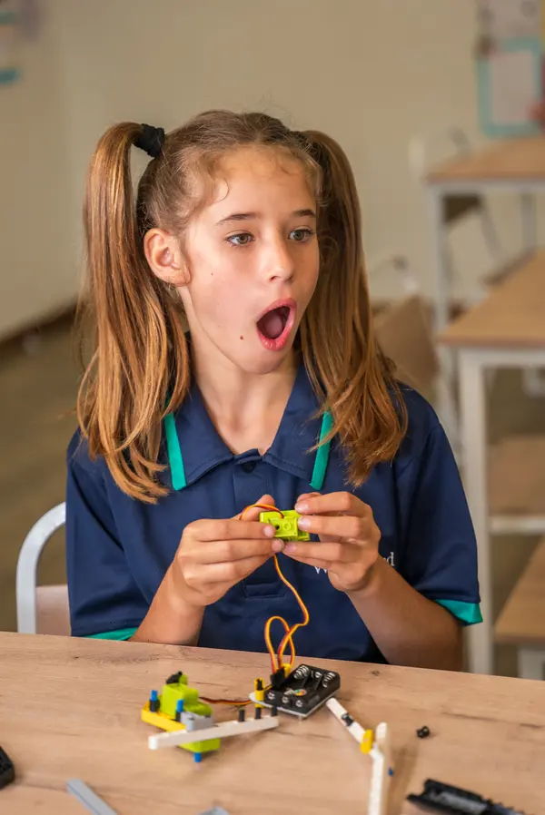 A child building a small electronics circuit